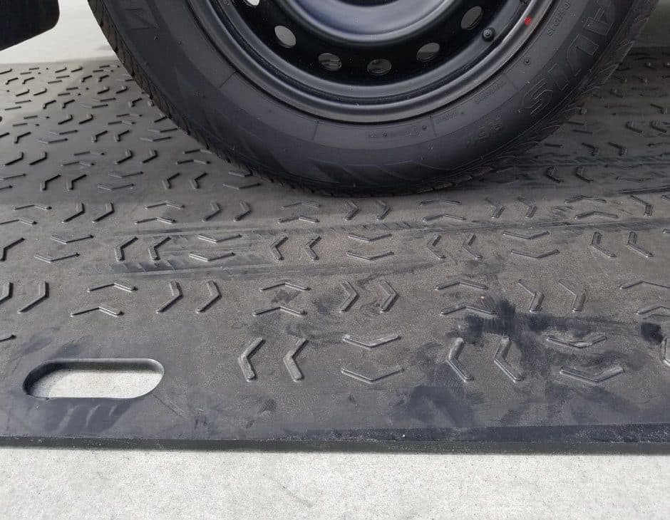 Vehicle tyre on a heavy-duty ground protection mat